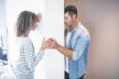 stockphotoupsetcouplestandingonoppositesidesofthewallandholdinghands399219859.jpg