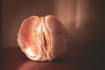 suva-vagina--stockphotopeeledgrapefruitdividedinhalfonaredtabledarklightingfemininehealthconceptfruitas2083102063.jpg